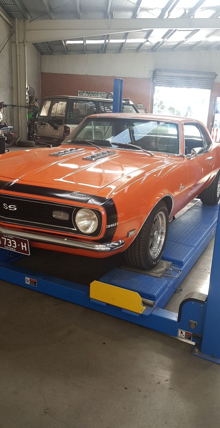 Orange sports car with hood open, showing a modified engine bay with red accents — Bay City A1 Tyres in North Geelong, VIC