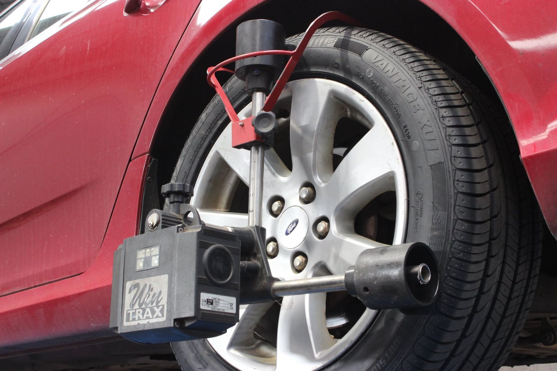 Wheel Alignment Sensor Mounted on A Red Car’s Front Wheel — Bay City A1 Tyres in North Geelong, VIC