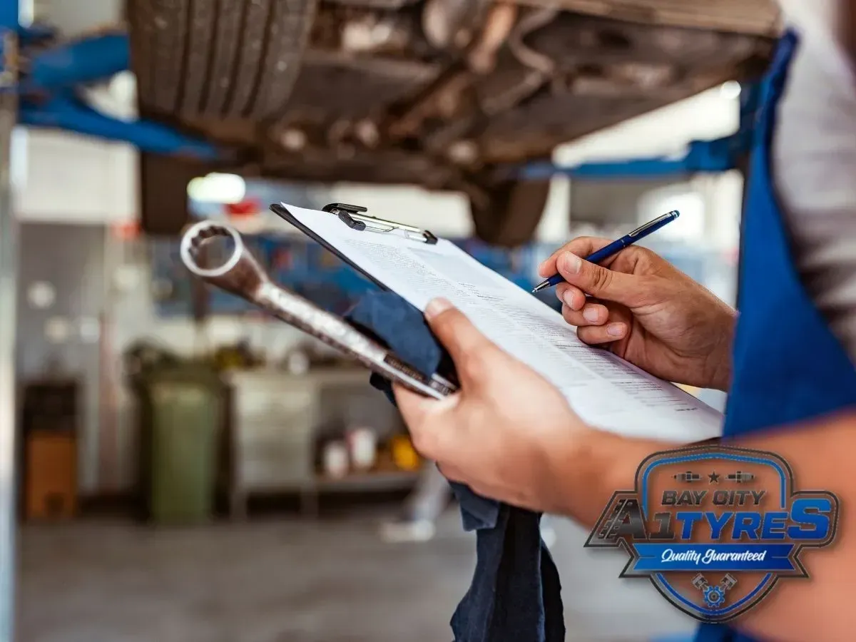 Holding a Clipboard and Pen in An Repair Shop, Inspecting a Vehicle — Bay City A1 Tyres in North Geelong, VIC