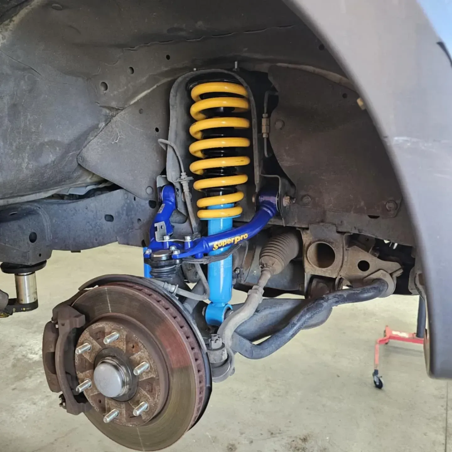 Car Wheel Well with Bright Blue Suspension — Bay City A1 Tyres in North Geelong, VIC