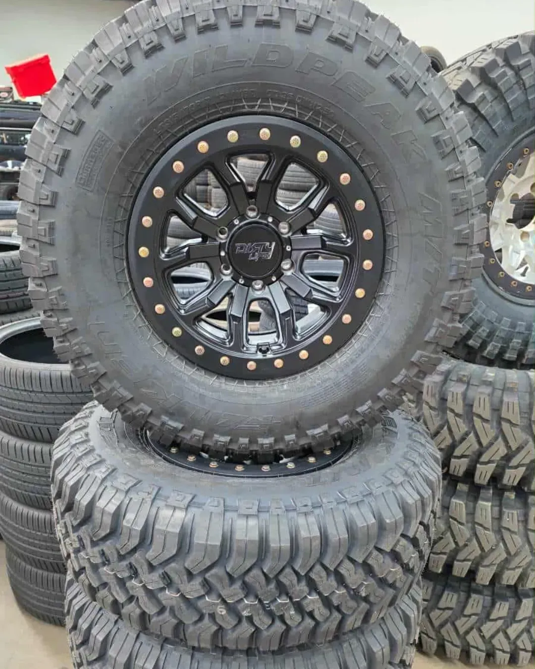 Stacked Off-Road Tires, with One Large Tire Mounted — Bay City A1 Tyres in North Geelong, VIC
