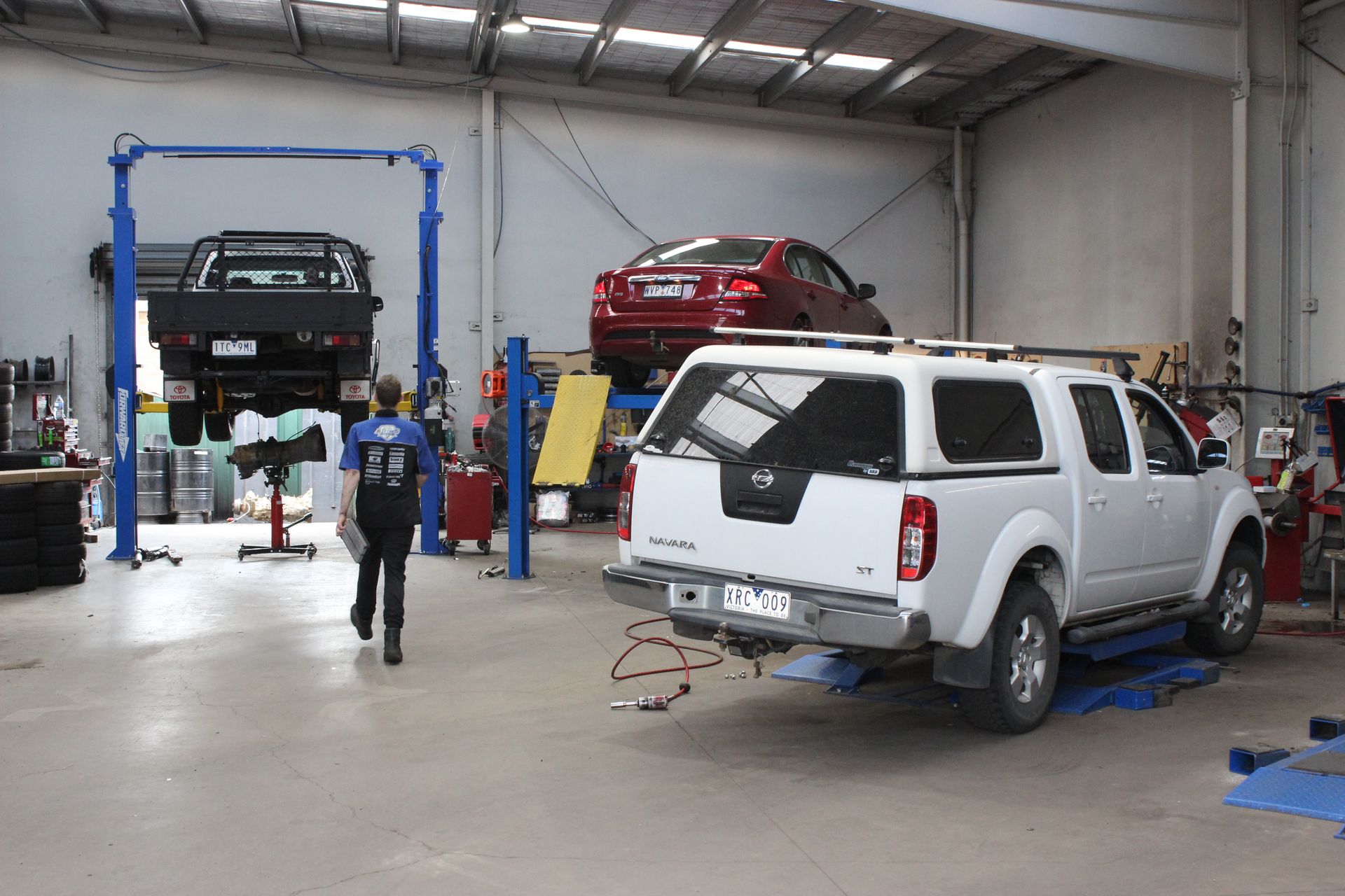 Auto Repair Shop with Two Lifted Vehicles, Including a White Suv — Bay City A1 Tyres in North Geelong, VIC