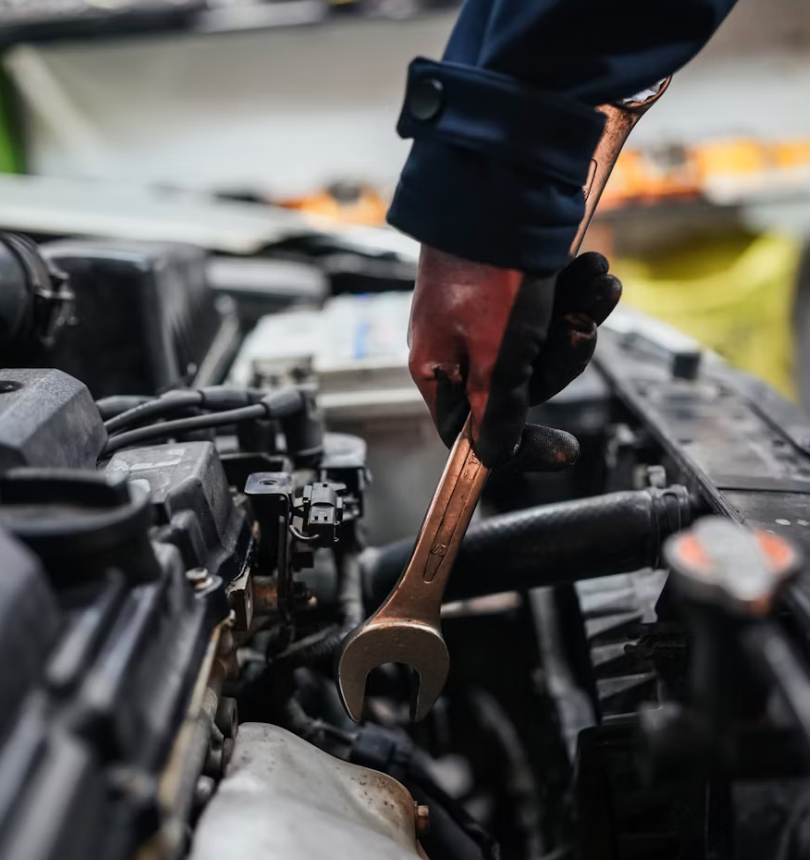 Mechanic Using a Wrench to Work on A Car Engine in A Garage — Bay City A1 Tyres in North Geelong, VIC