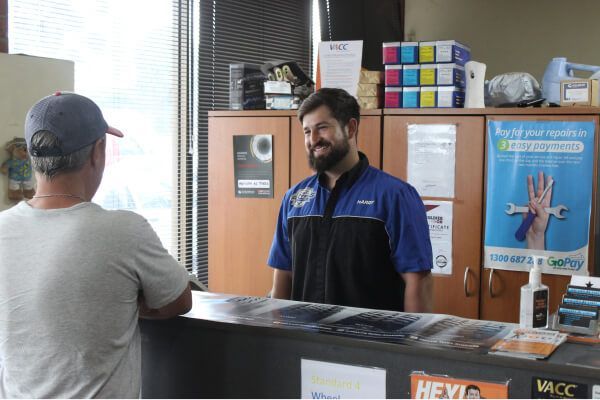 Customer Speaking with A Staff Member at A Counter in A Bright Office Lobby — Bay City A1 Tyres in North Geelong, VIC