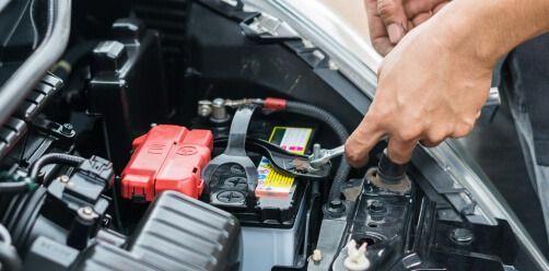 Hand Using Jumper Cables To Charge A Car Battery — Bay City A1 Tyres in North Geelong, VIC