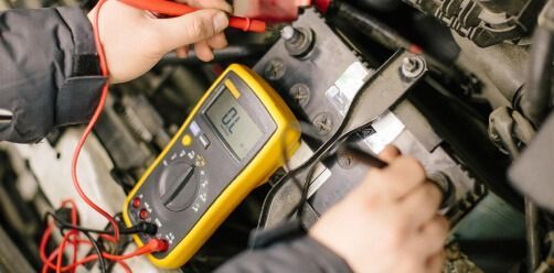 Hands Using A Yellow Multimeter To Test Wiring — Bay City A1 Tyres in North Geelong, VIC