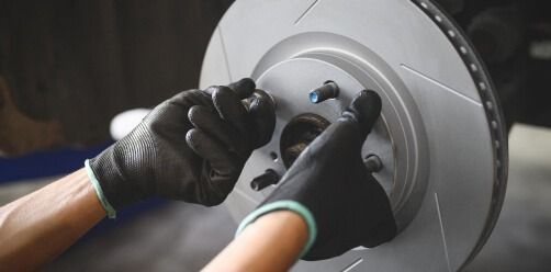 Gloved Hands Adjusting A Car Brake Disc With A Wrench — Bay City A1 Tyres in North Geelong, VIC