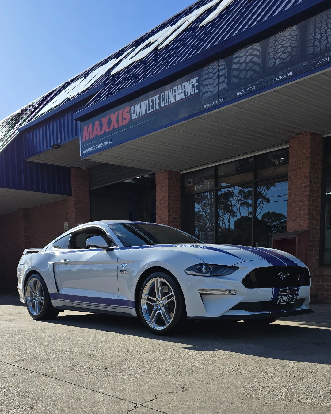 White Ford Mustang Parked Outside a Dealership with A Blue Awning — Bay City A1 Tyres in North Geelong, VIC