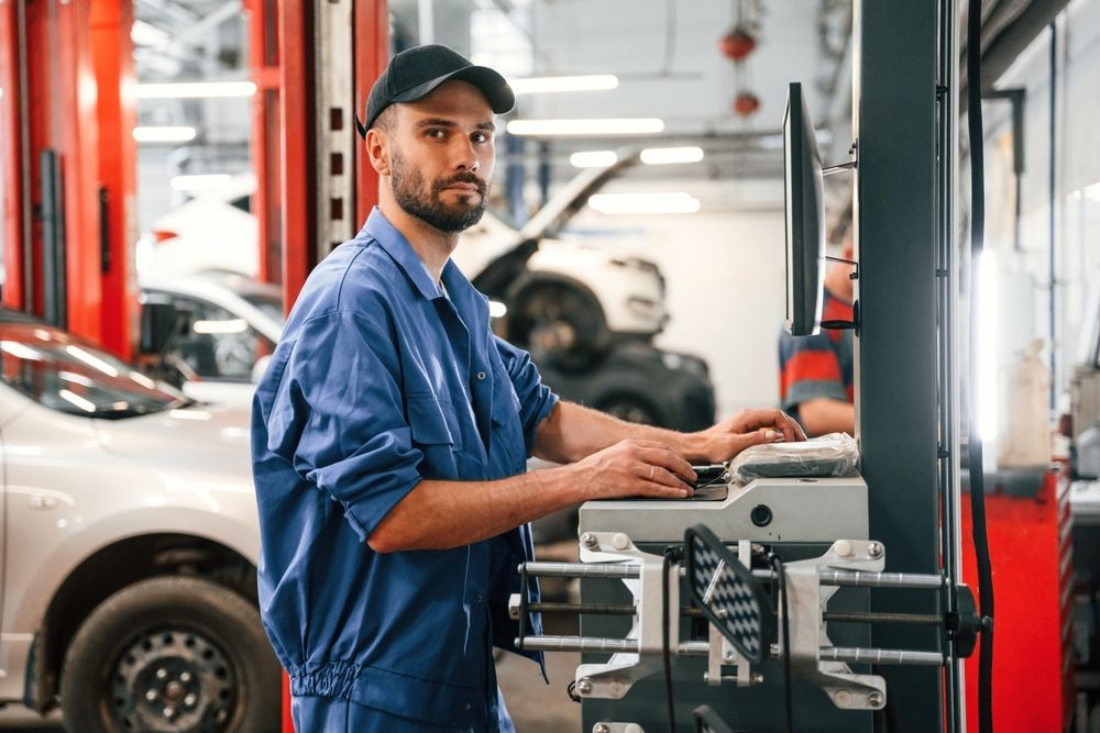 Mechanic in Blue Coveralls Using a Diagnostic Machine in An Auto Repair Shop — Bay City A1 Tyres in North Geelong, VIC