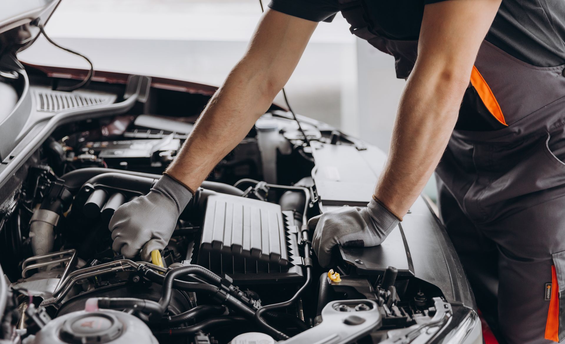 Mechanic Working Under an Open Car Hood in A Garage — Bay City A1 Tyres in North Geelong, VIC