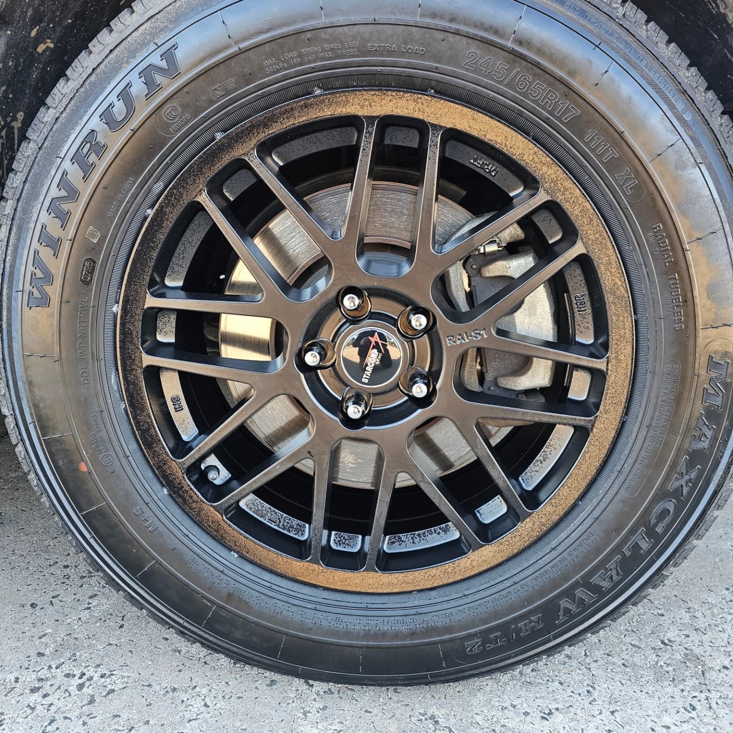Close-Up of A Black Alloy Car Wheel with A Mounted Tire and Exposed Lug Nuts — Bay City A1 Tyres in North Geelong, VIC