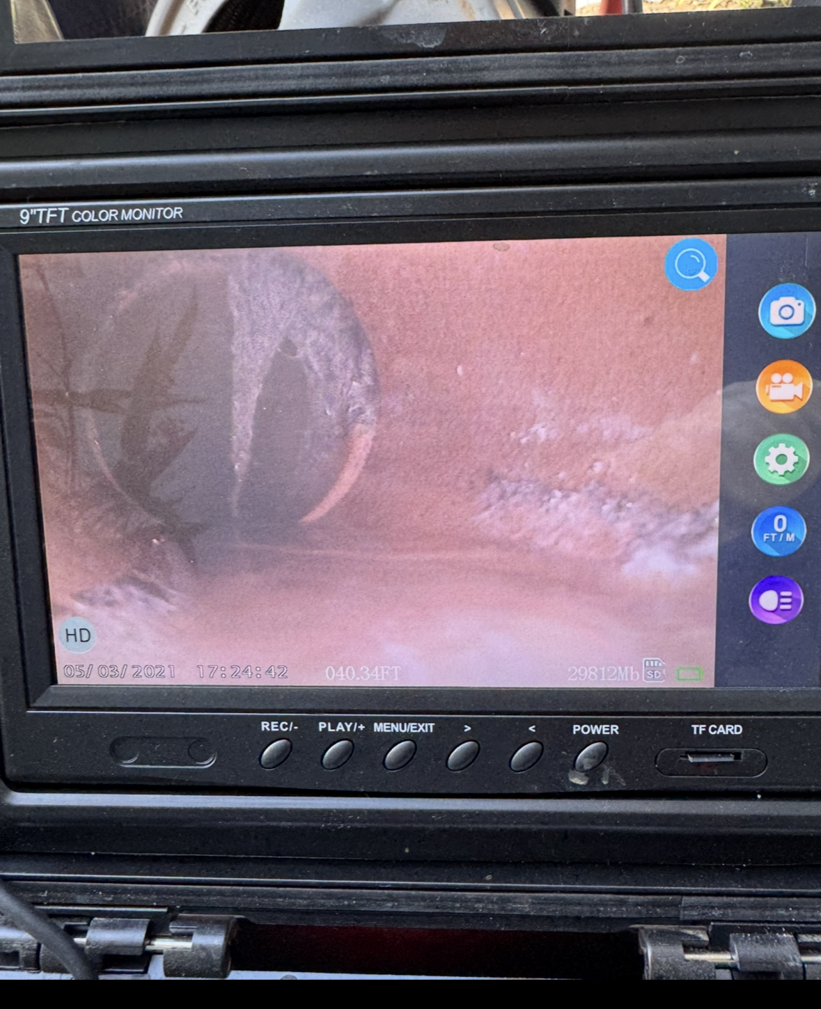 Dashboard screen showing a live video feed with a red-tinted close-up view and on-screen control icons.