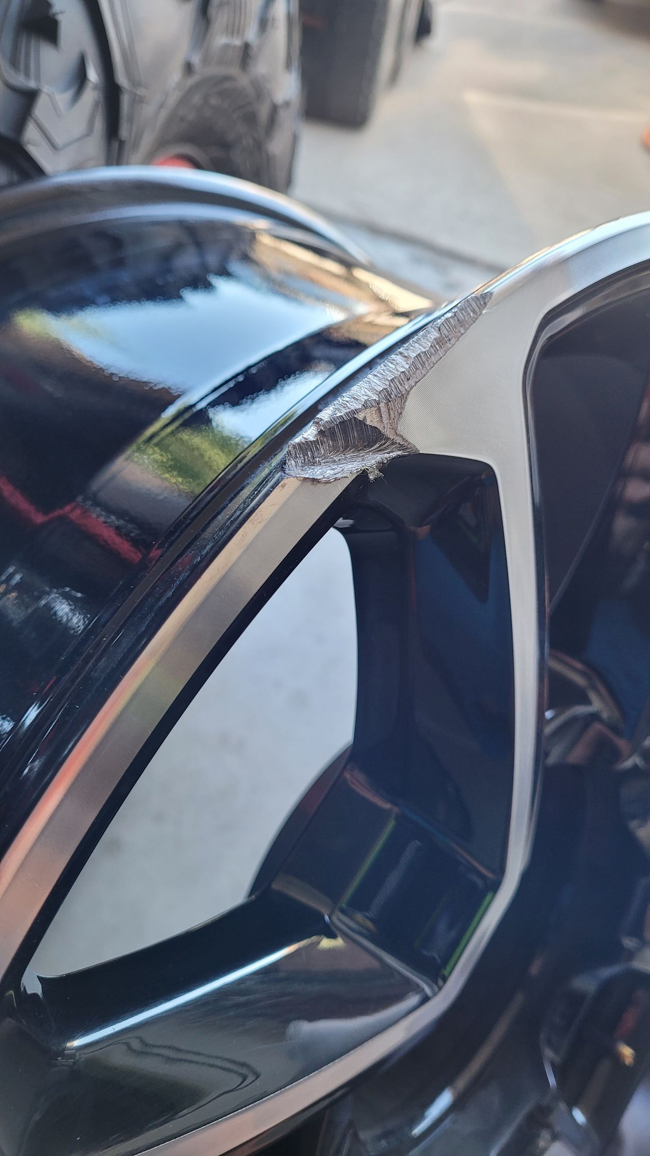 A close up of a car with a broken side mirror.