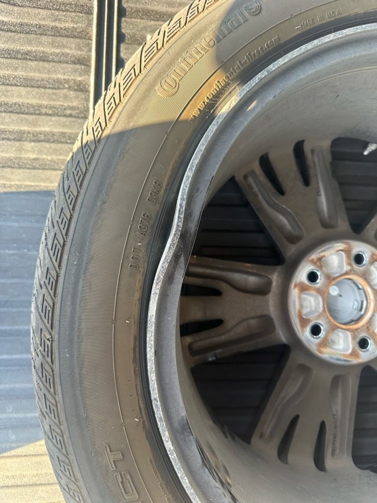 A close up of a tire and wheel on a car.