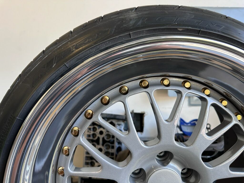 A close up of a car wheel with a tire on it