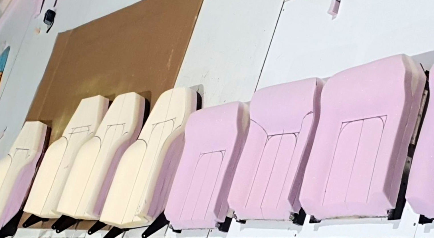 A row of molded foam automotive seat cushions in white and light pink — Tidy Trim Newcastle in Carrington, NSW