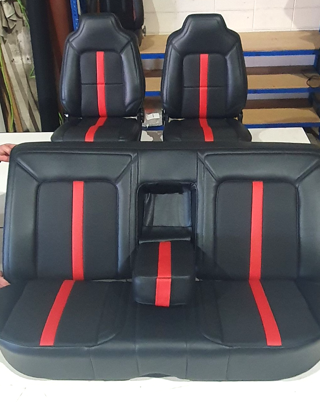 A set of black vehicle seats with a central red vertical stripe on each — Tidy Trim Newcastle in Carrington, NSW