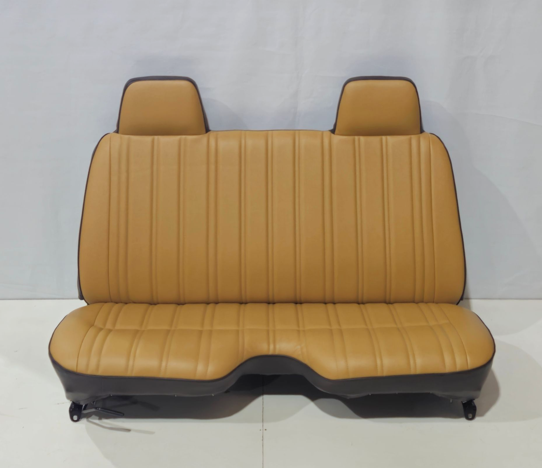 A tan and brown leather bench seat with two built-in headrests — Tidy Trim Newcastle in Carrington, NSW