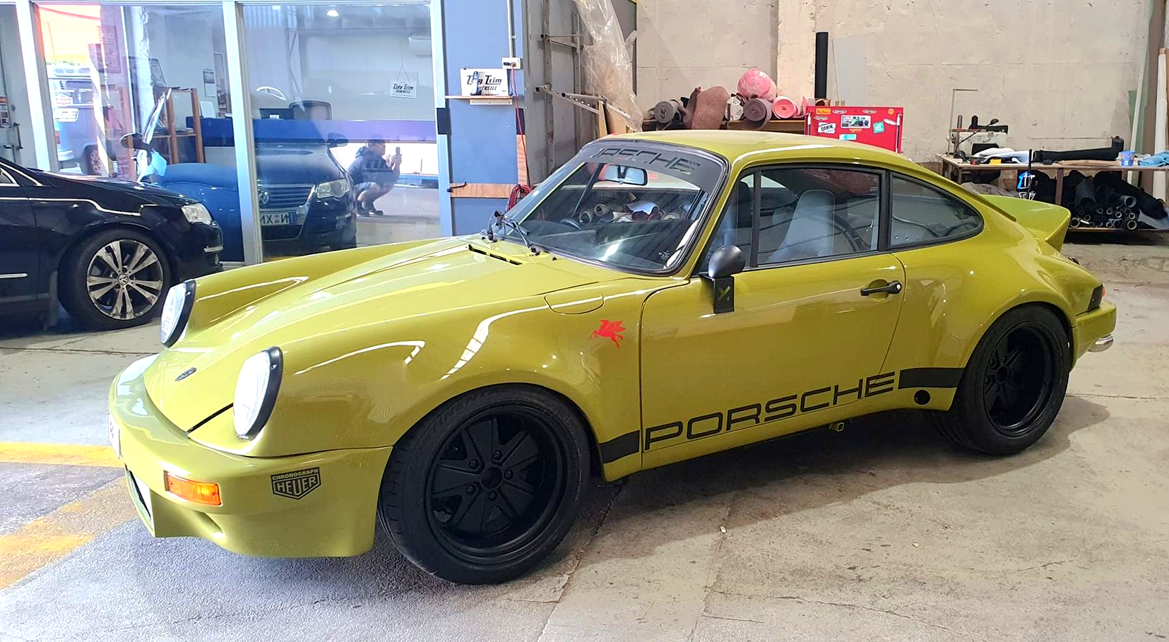 A mustard yellow classic Porsche 911 coupe with black rims and side decals — Tidy Trim Newcastle in Carrington, NSW