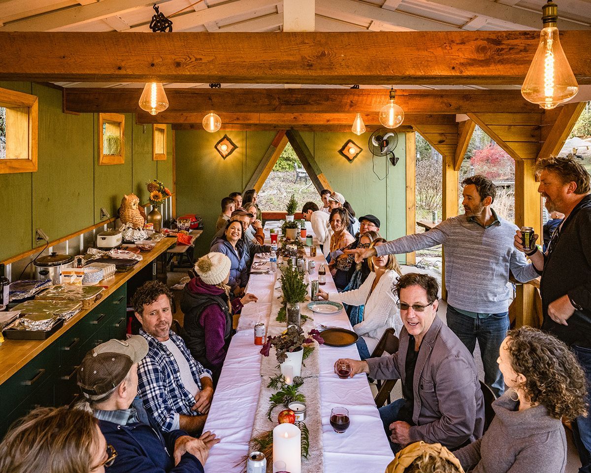 A group of people gathers at a long table.