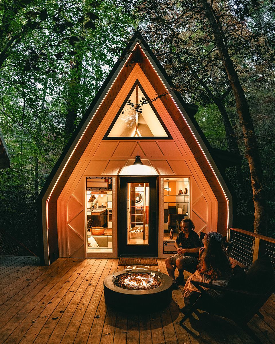 An A-frame cabin in the woods.