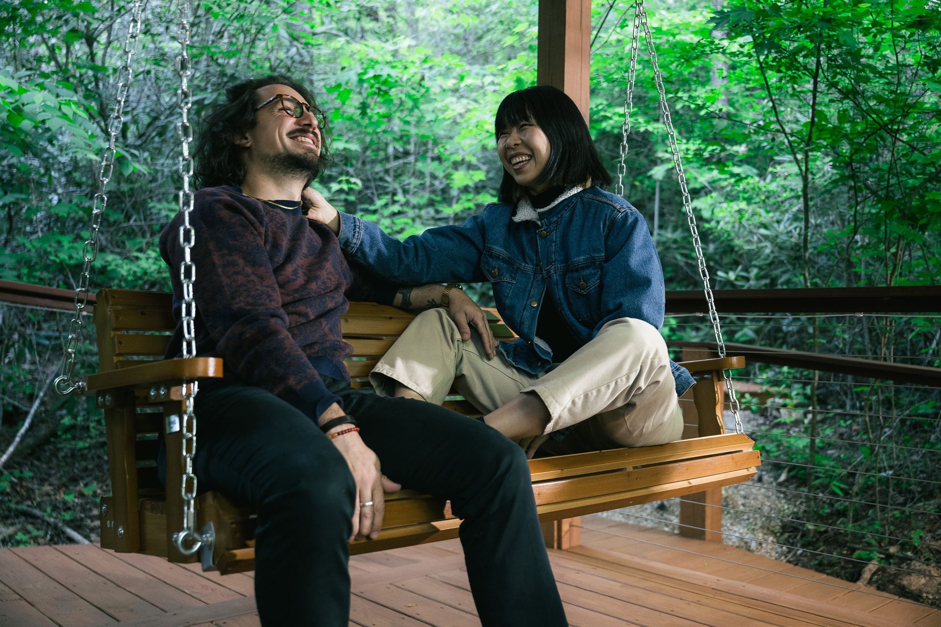 A couple relaxes on a hammock