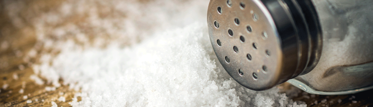 Salt shaker with salt granules.