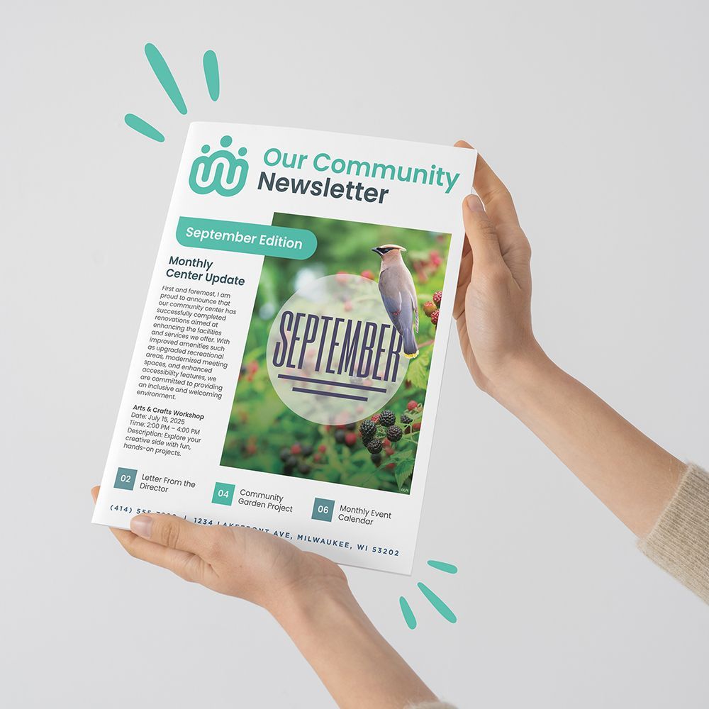 Hands holding up a community newsletter