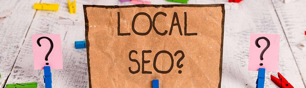 A piece of cardboard with the words `` local seo '' written on it.