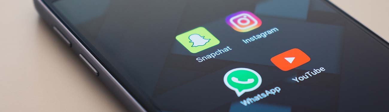 A close up of a cell phone with three apps on the screen.