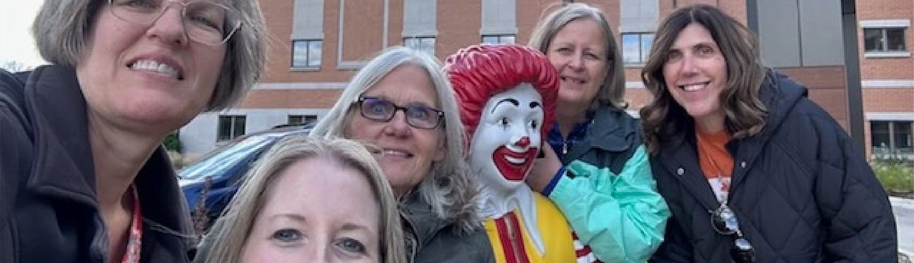 LPi employees with a statue of Ronald McDonald