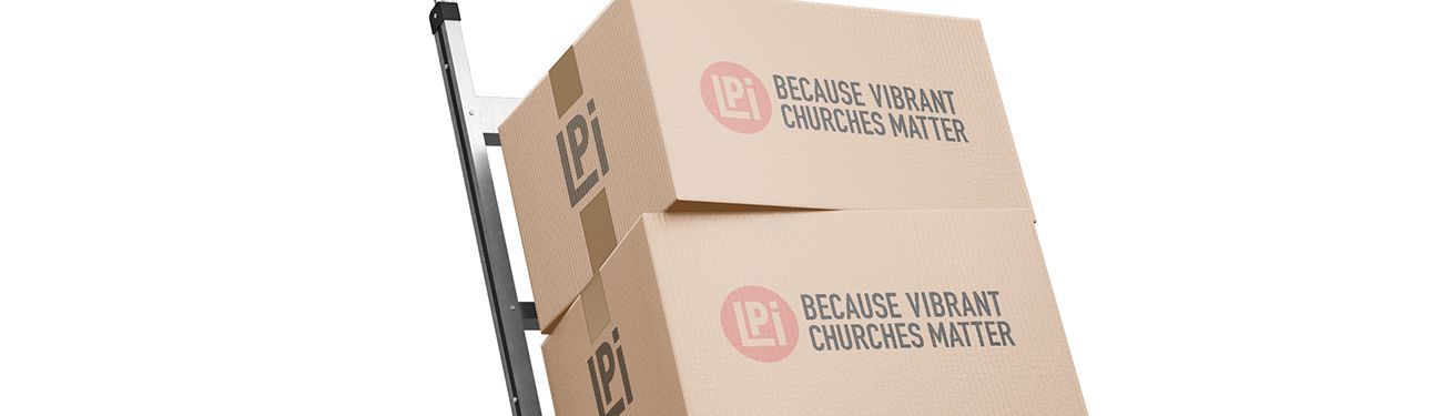 Two cardboard boxes are sitting on top of a hand truck.