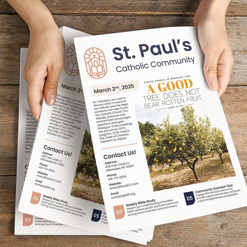 Hands hold a printed Catholic bulletin.