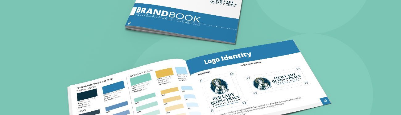 A brand book and open brand book sitting on top of each other on a green surface.