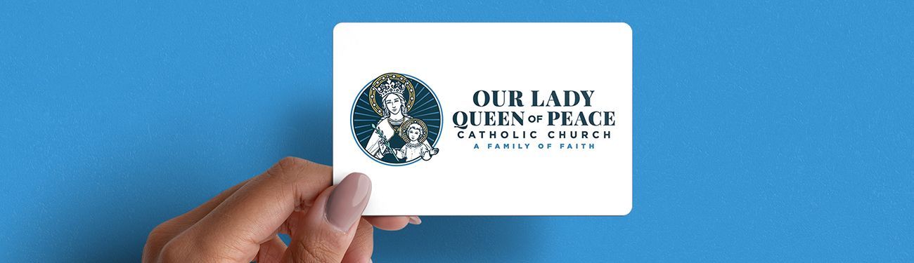 A person is holding a branded card that says Our Lady Queen of Peace.
