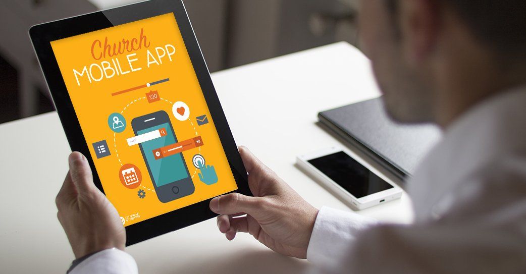 A man is holding a tablet with a church mobile app on it.