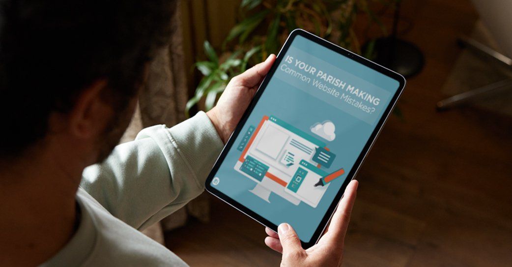 A man is holding a tablet in his hands.