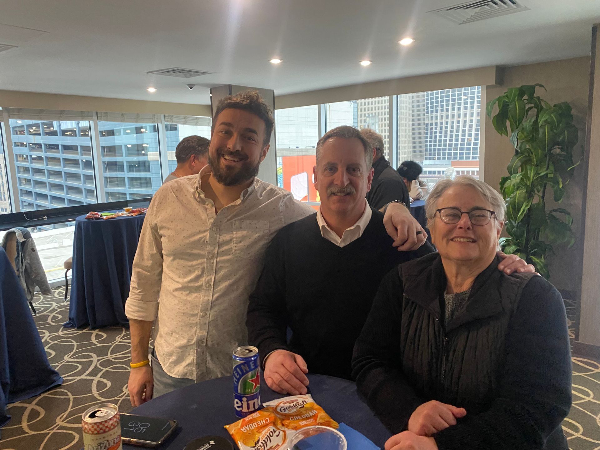 two men and a woman smiling for the photo