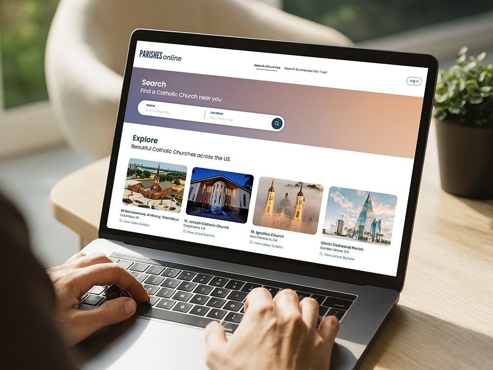 Hands typing on a laptop showing a  website with destination cards and search bar.