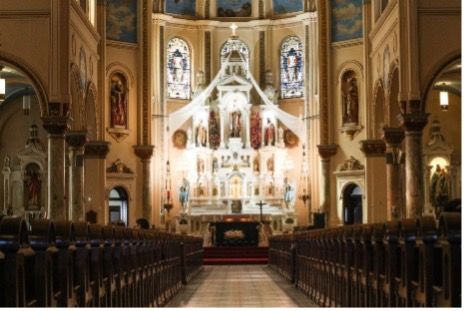 The inside of a church with stained glass windows.