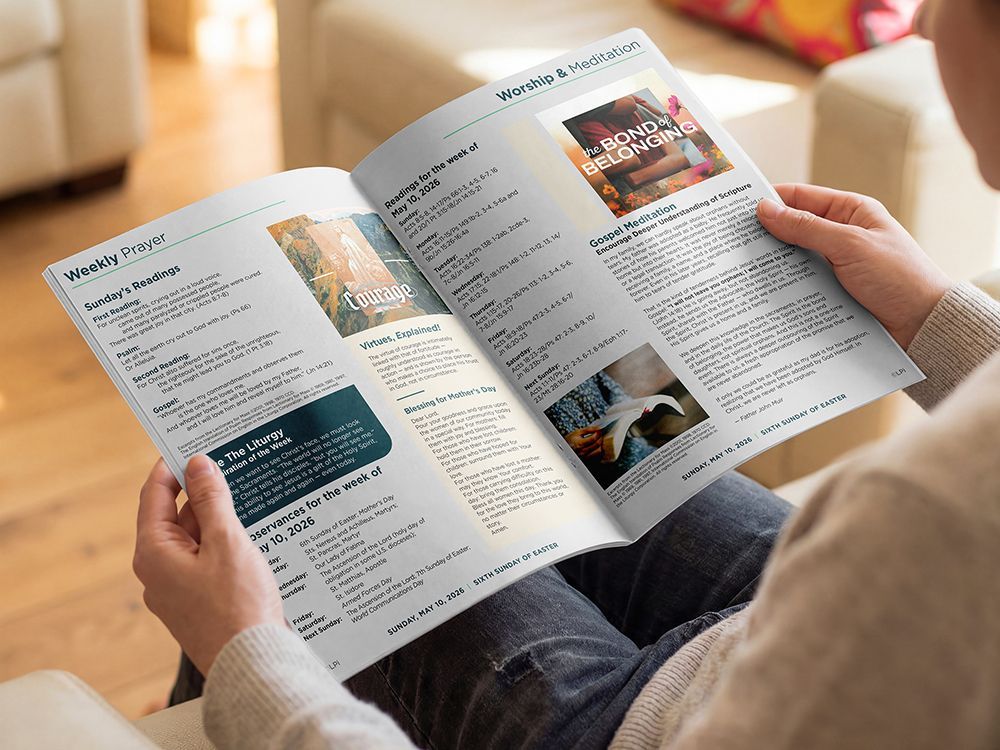 Person holding open bulletin in a bright living room