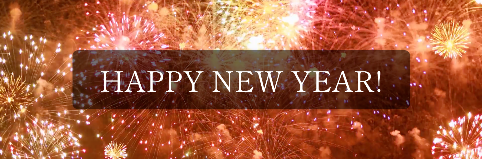 A happy new year sign with fireworks in the background.