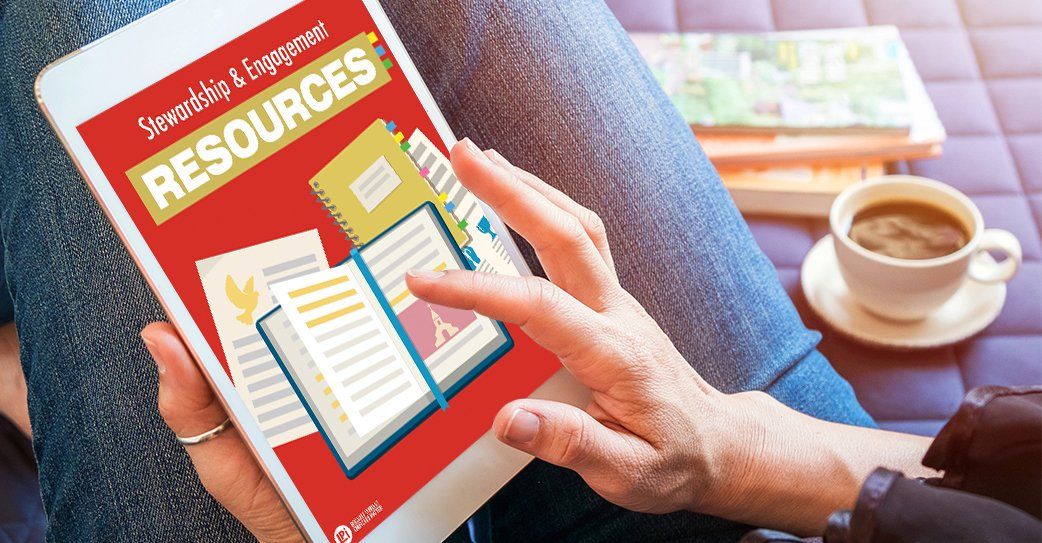 A person is holding a tablet with a book on it.