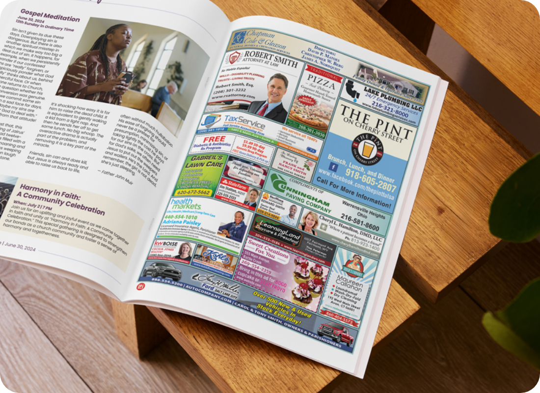 An open bulletin is sitting on a wooden stool showing  a page with ads.