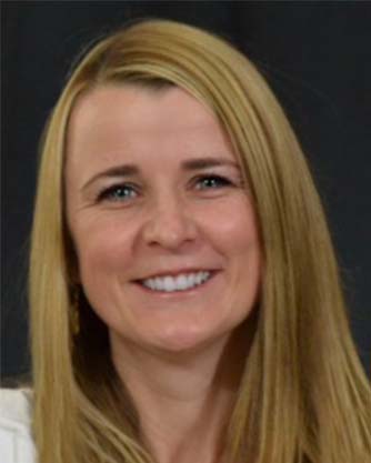 A woman with long blonde hair is smiling for the camera.
