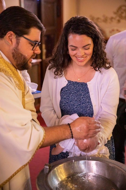 A man is baptizing a woman in a church.