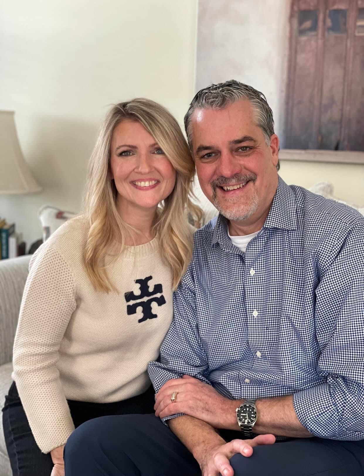 A man and a woman are sitting next to each other on a couch.