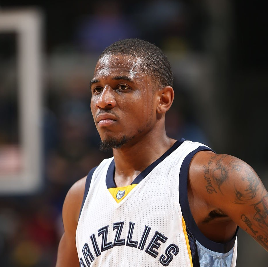 A man wearing a grizzlies jersey looks to the side