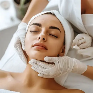 A woman is getting a facial treatment at a beauty salon.