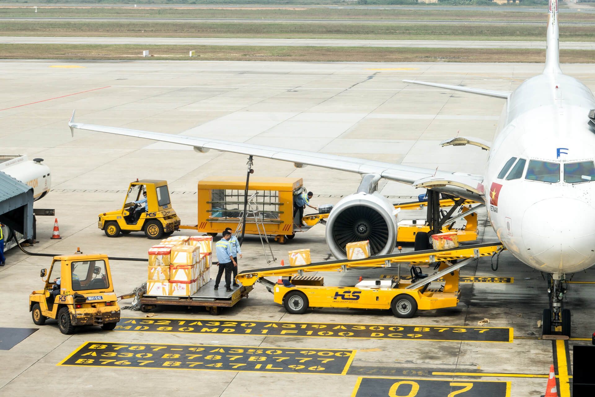 An airplane is being loaded with cargo at an airport